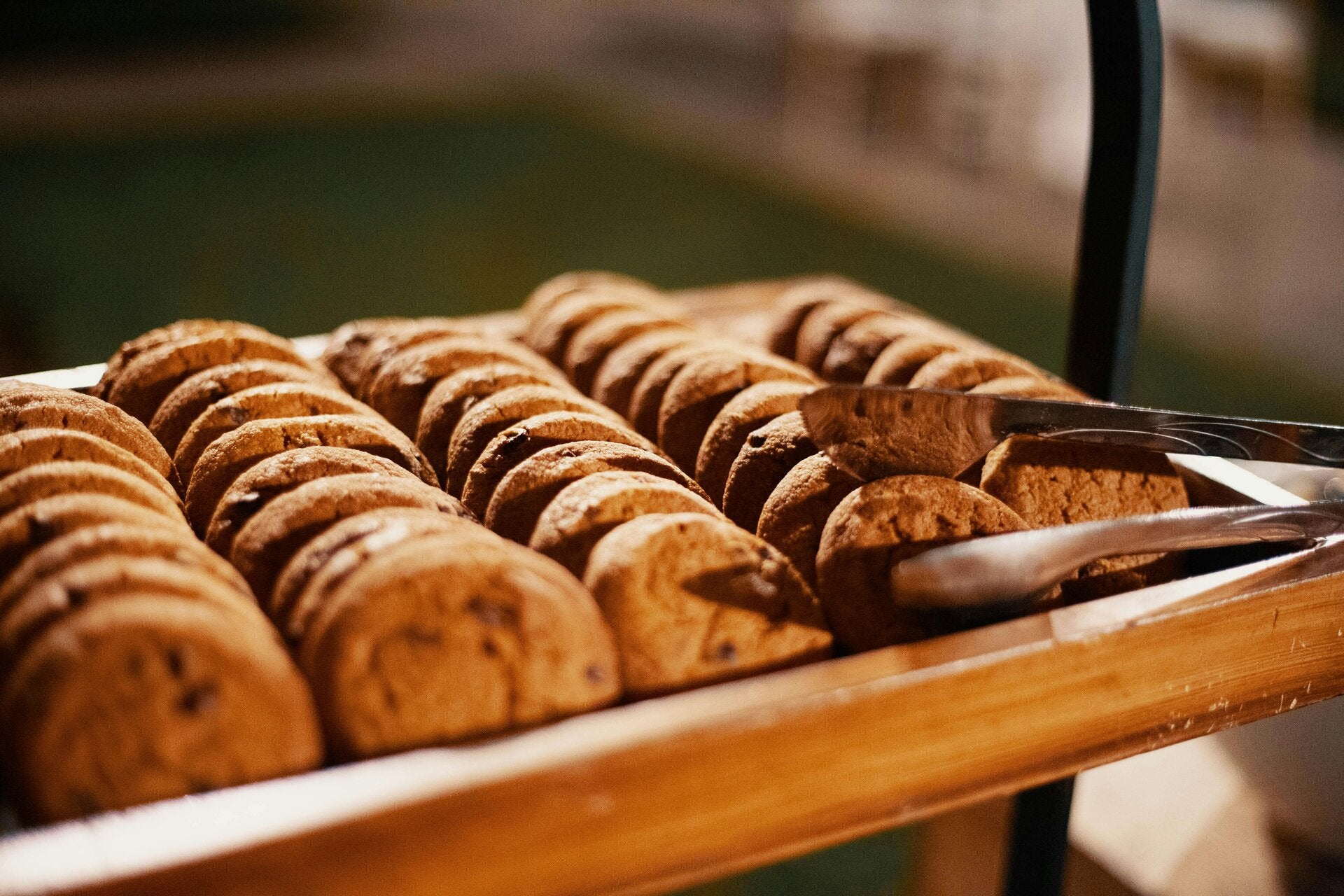 Tray of cookies, with metal tongs resting on the tray